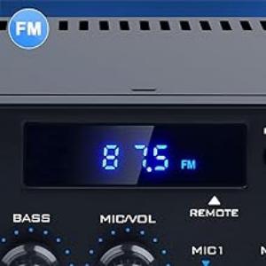 Digital FM radio display panel showing blue LED numbers '87.5', with control buttons for bass, mid-vol, and remote visible below.