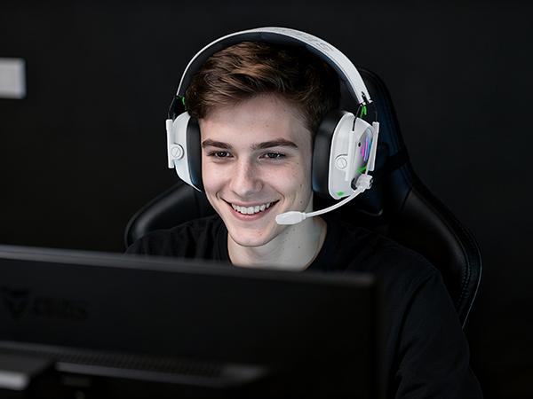 Multiple people wearing headphones in dark setting, appearing to be focused on audio content.