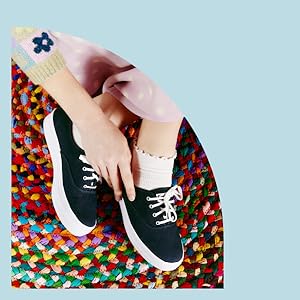 woman wearing black canvas lace up sneakers