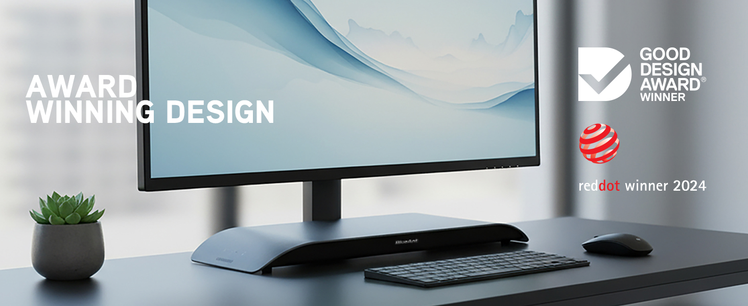 Charcoal SoundBlade under monitor on minimalist desk with award logos and premium design