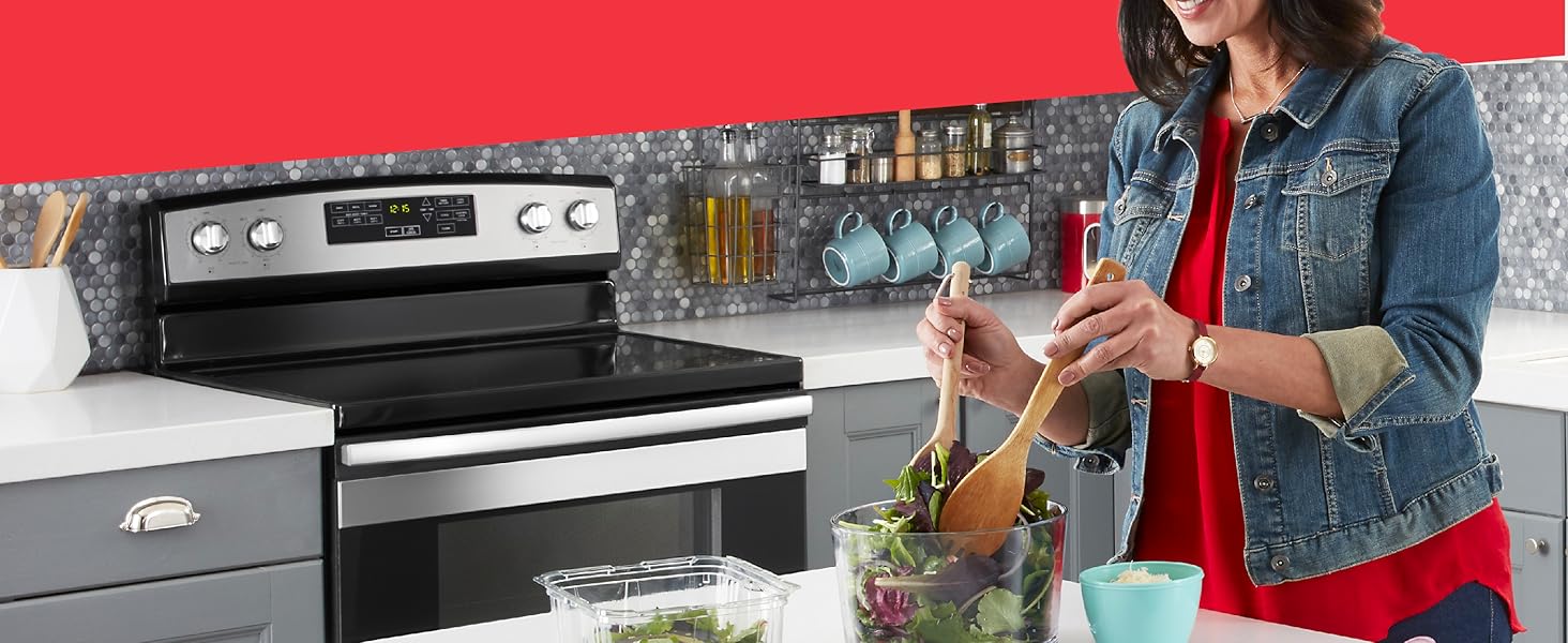 A woman making a salad in her kitchen is shown.