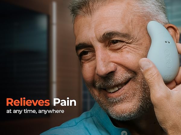 person holding the TMJ massage tool against their cheek and smiling