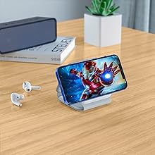 charger folded to support iphone for viewing on a wooden table with airpods next to it