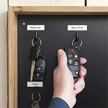 Car key hooks labeled with paper tapes