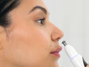 Woman using nose trimmer