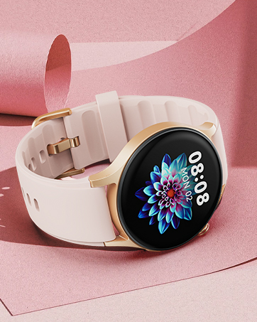 Smartwatch with round display showing colorful floral design and digital time. White silicone strap and gold-toned casing on pink background.