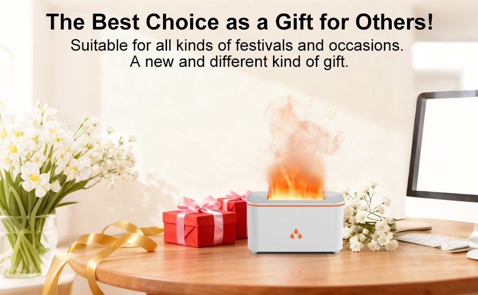 White minimalist desk setup with office accessories including potted succulent plant, laptop stand, and decorative items arranged on wooden surface against light wall.