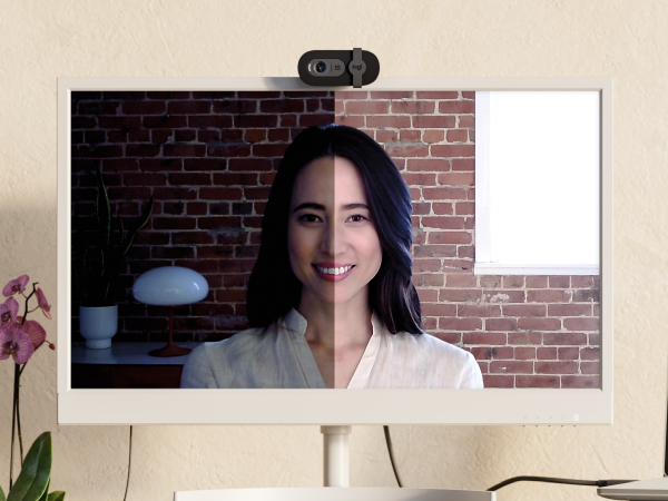 a woman having a video call using brio 101 full hd webcam for meetings and streaming