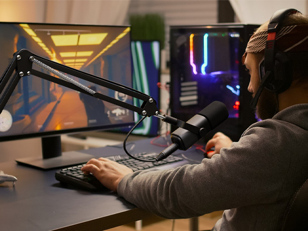 a man sitting at a desk playing a video game