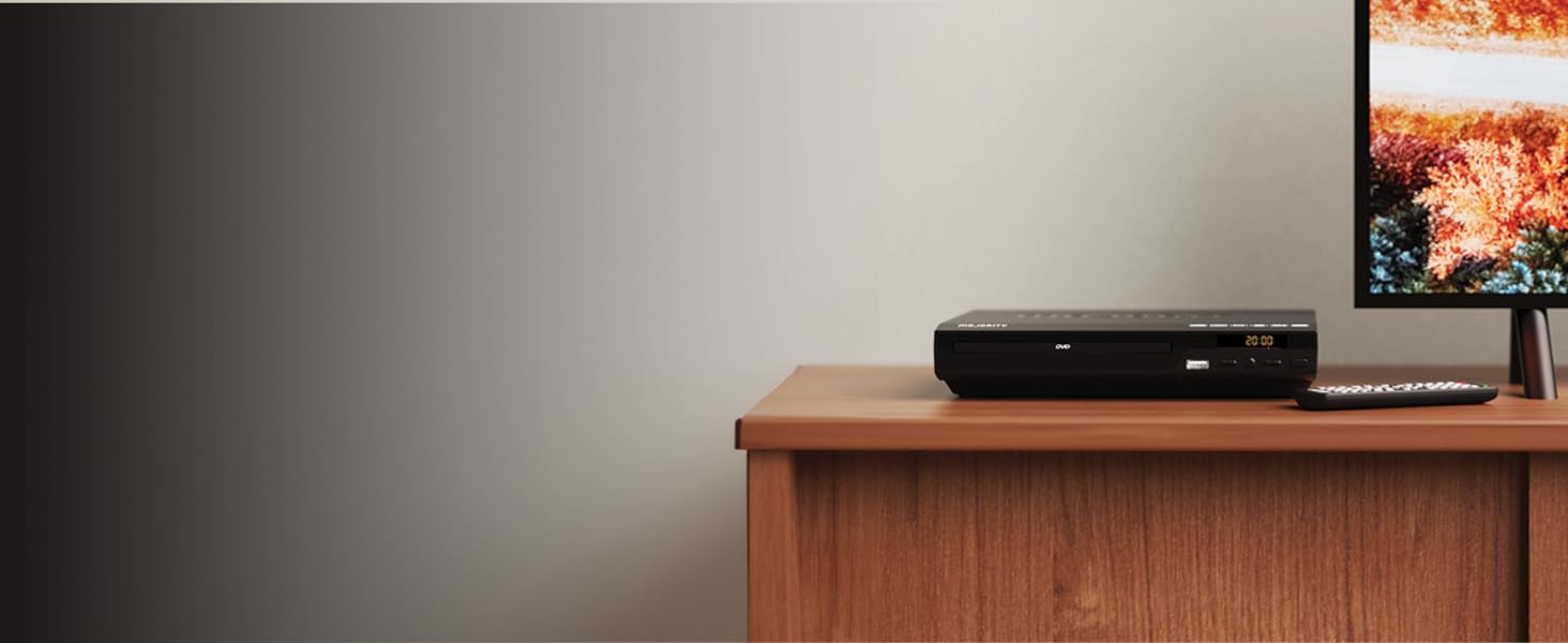 DVD player for smart tv with remote control standing on shelf in living room next to the tv.