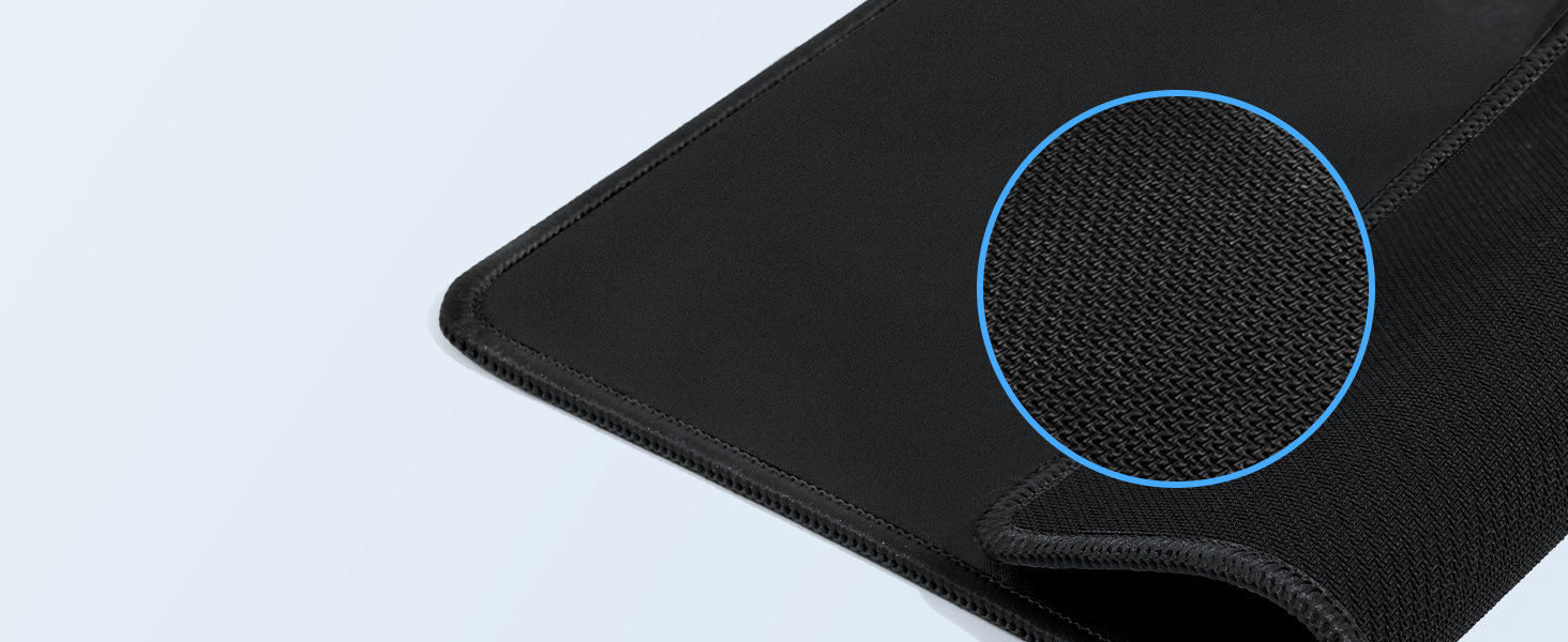 Close-up of a black textured surface, likely a mousepad or desk mat, with a circular detail highlighting the fabric weave.