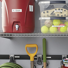Garage shelving unit with red cooler and storage bins labeled