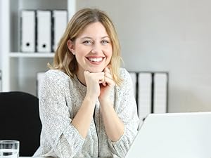 Happy office employee using task planner notepad for productivity, time blocking, and organization.