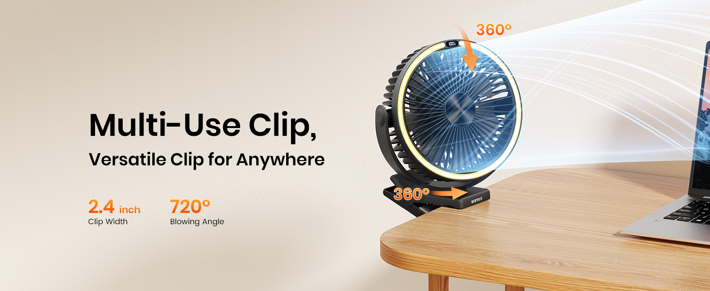 Black clip-on desk fan with 360° rotation, placed on a wooden desk beside a laptop.