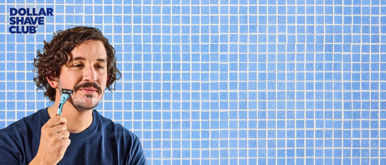 Man shaving with dollar shave club razor