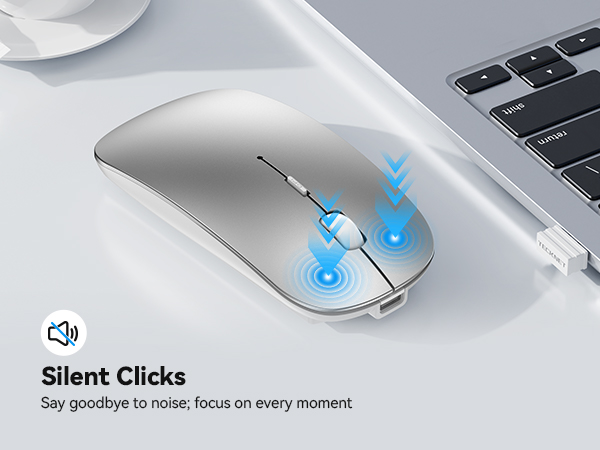 Text reads "Silent Clicks" with "Say goodbye to noise. Focus on every moment." Close-up of white wireless mouse with blue click indicators on dark surface near keyboard.