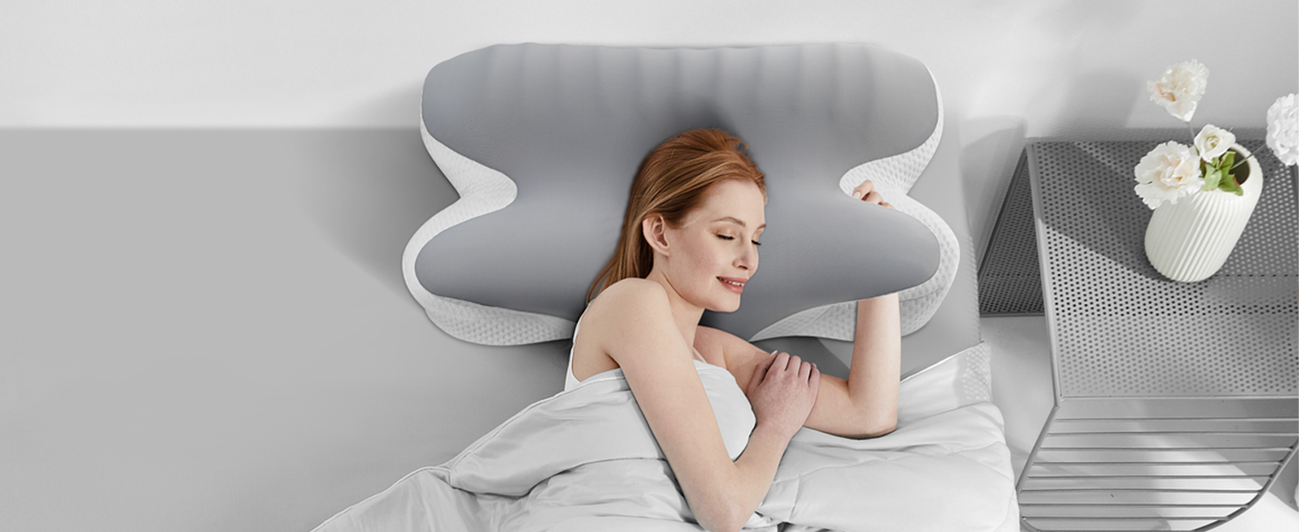Curved ergonomic pillow with white cover on a bed. Person lying on side using pillow, demonstrating its shape-conforming properties for neck and head support.