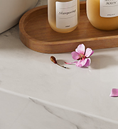 Wooden tray or surface with small pink flower decoration and partial view of containers.