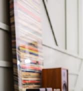 A decorative photo and top half of a dayton audio speaker in a living room