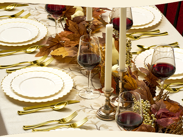 Ivory Scalloped Plastic Plates with Gold Trim on a fall table with red wine glasses and candles