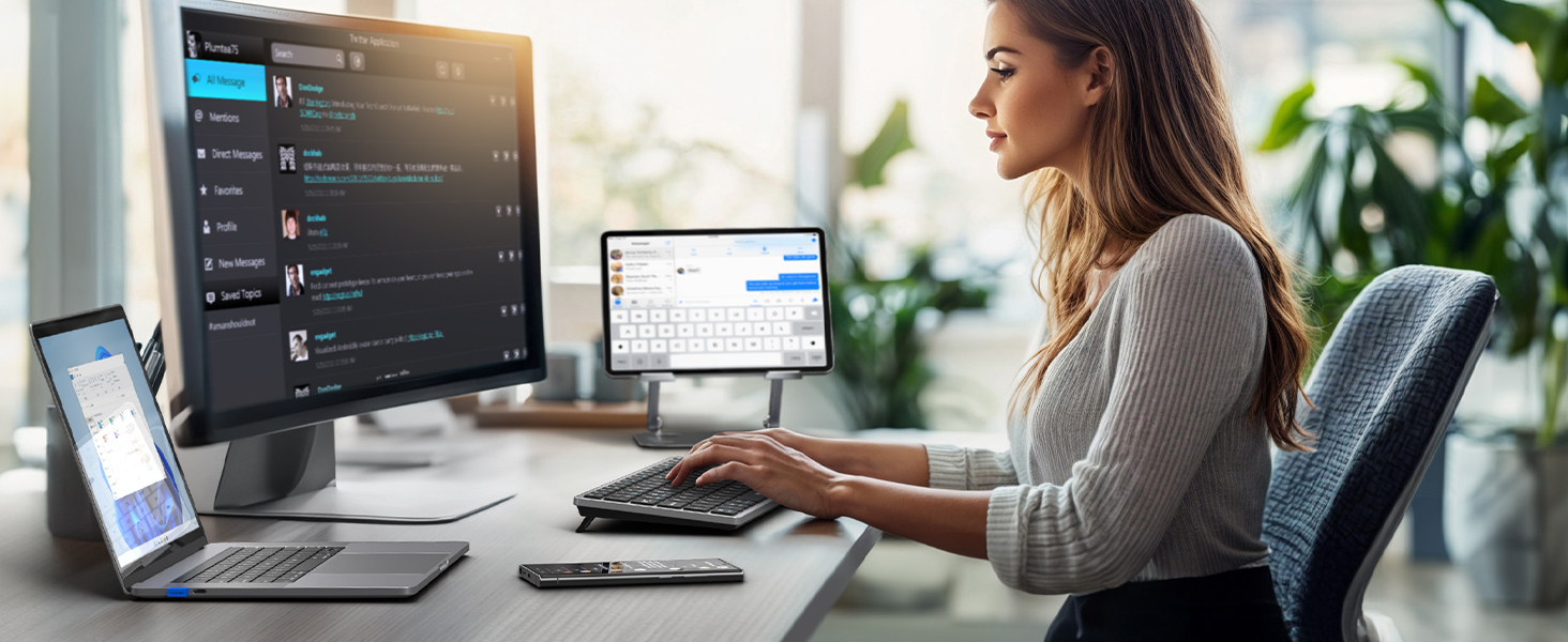Multi-monitor desktop workstation setup showing multiple displays with various applications and windows open in a bright office environment with plants.