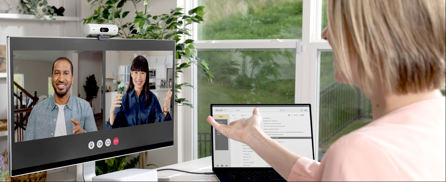 An angle image of a woman having a video call on a computer using Brio 500