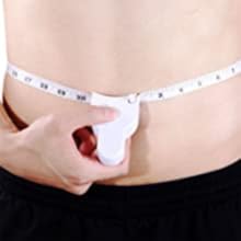 a person measuring a waist with a tape measure.