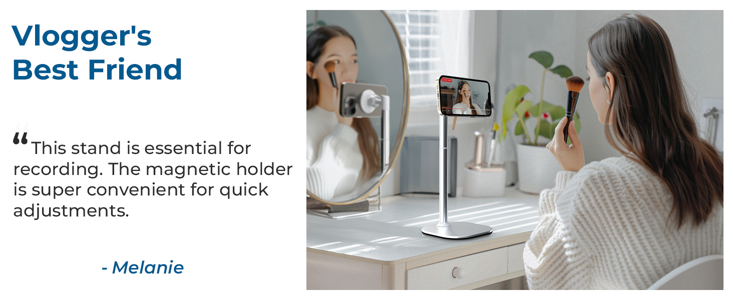 Phone holder stand demonstrated on desk setup with mirror and plants, marketed as 'Vlogger's Best Friend' with magnetic adjustment features.