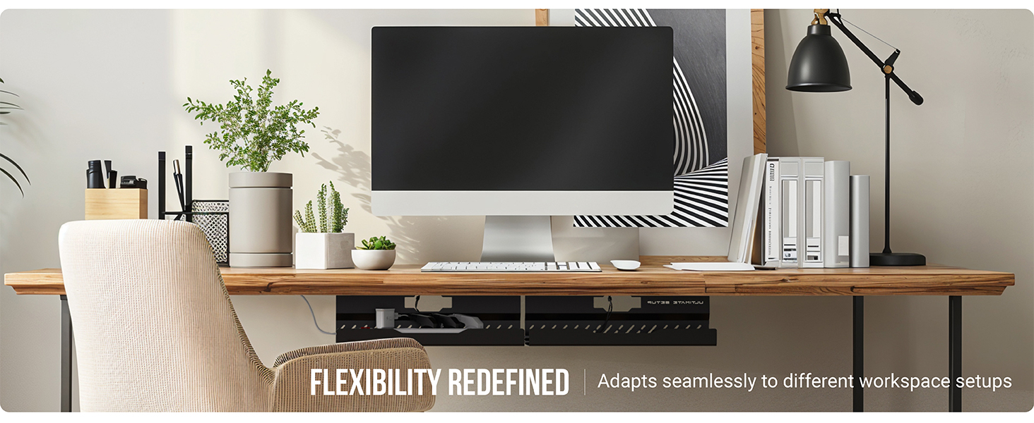 a desk with a computer and a plant on it.