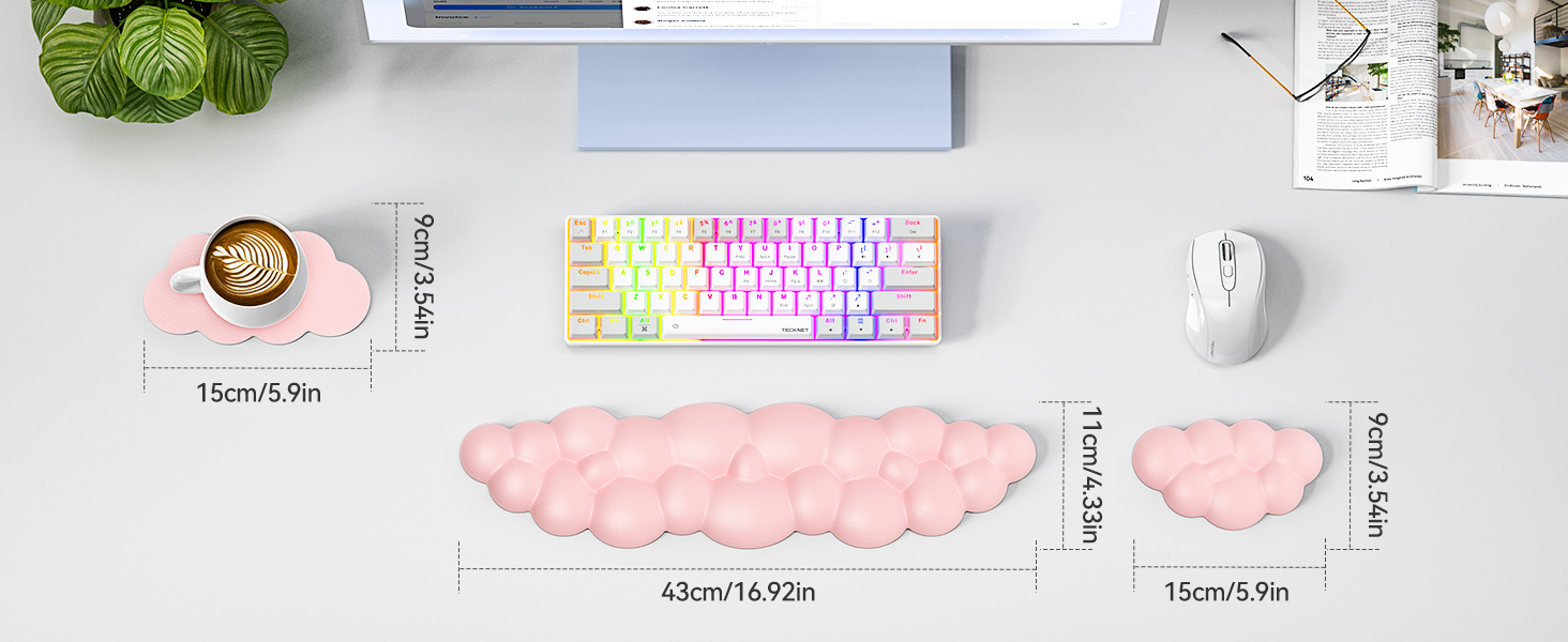 Desk setup featuring a compact white keyboard with colorful pastel keys, a white mouse, and pink cloud-shaped mousepads in different sizes. Dimensions are provided for the mousepads.