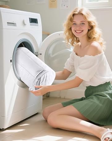 Interior laundry room scene with modern white front-loading washing machine. Person in white top and green skirt holding white laundry near the appliance in sunlit space.