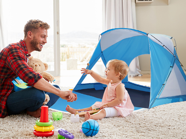 a dad and his daughter are playing beside a tent indoor