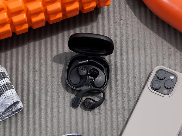 Using the IP55 waterproof earbuds at the gym, placed on the gym mat surrounded by gym essentials