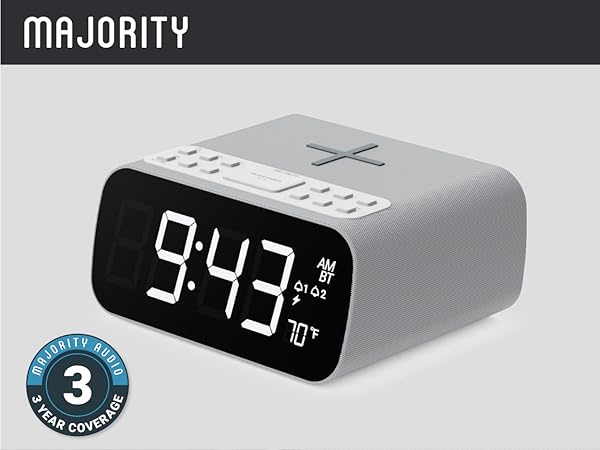 Digital alarm clock with black face, bedside radio, buttons, wireless charging pad, and 70°F display