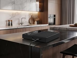 A mini coffee scale on a premium home kitchen counter, charging via USB-C.