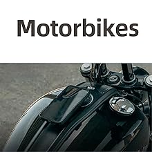 Close-up of a black motorcycle's fuel tank, handlebars, and instruments. The tank has a glossy finish with visible reflections. A smartphone is mounted on the tank.
