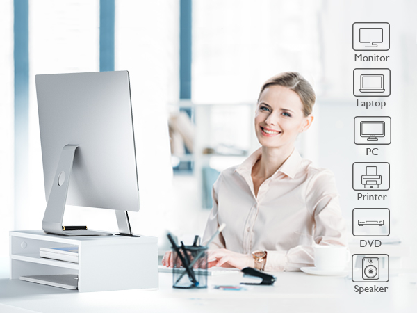a woman sitting at a desk with a computer