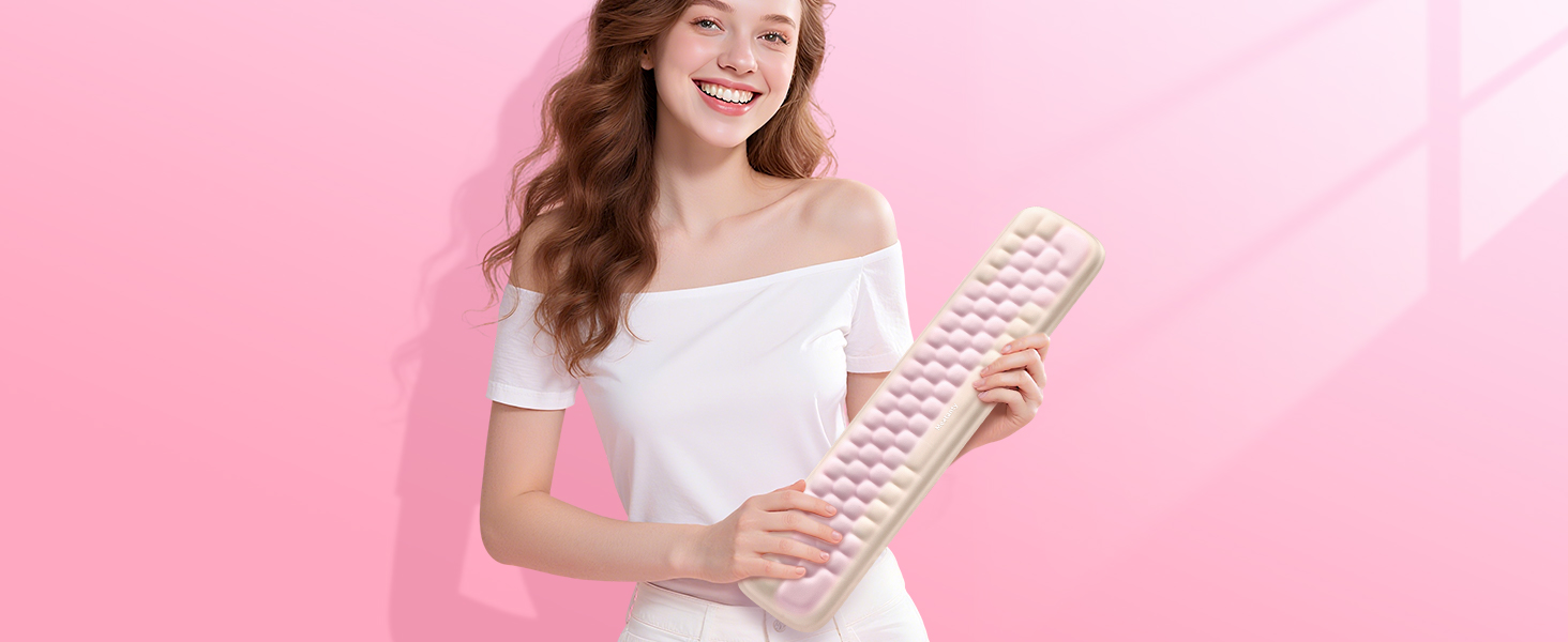 Pink background setting with person holding a computer keyboard.