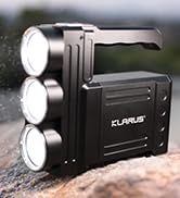 Black portable device with three circular LED lights mounted on top, featuring a digital display panel on the front.