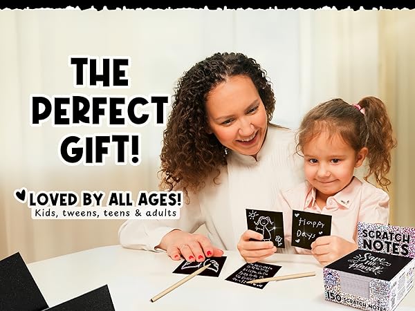 Mom and daughter smiling as they enjoy creating sparkling scratch art notes together at home.