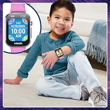 Kid shows off the watch face he has chosen.