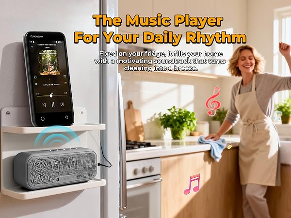 MP3 player on the fridge playing music, paired with a speaker while a person cleans in the kitchen