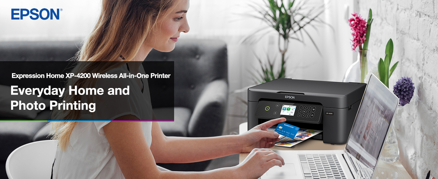 Person shopping online with Expression Home XP-4200 printer sitting on desk in the background. 