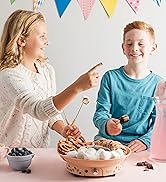 a young girl and boy enjoying dipping marshmallows and pretzels in the Kusini fondue maker