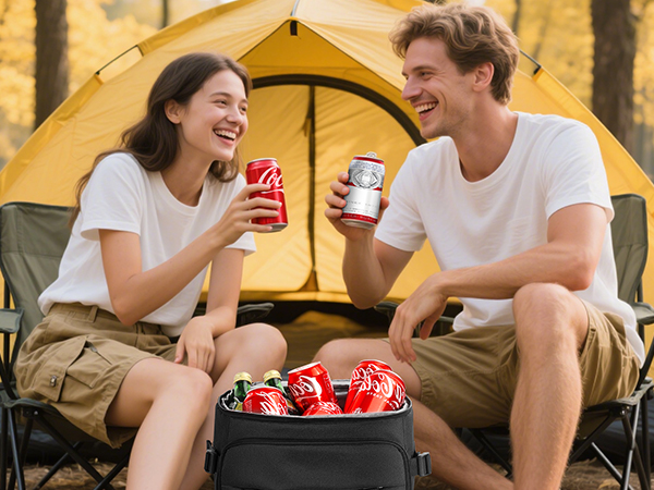 A couple camping in the forest, opening their cooler backpacks and drinking drinks