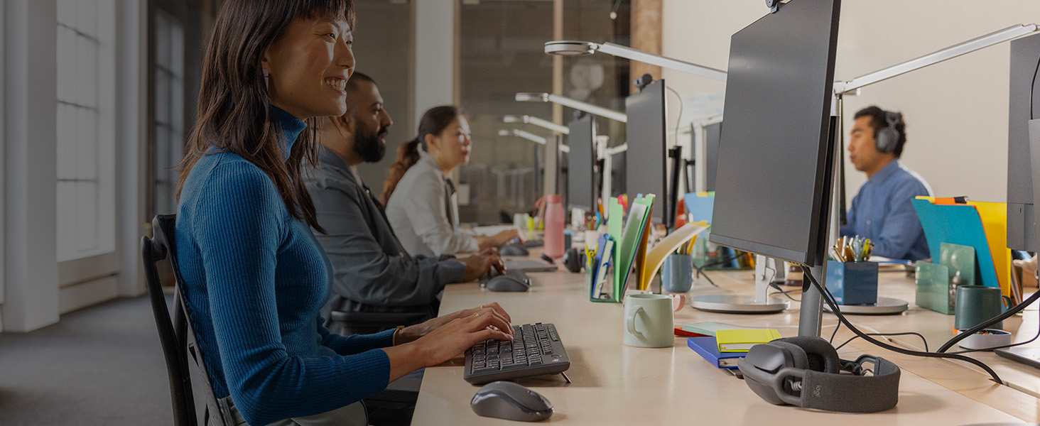 a woman using mk370 combo for business wireless keyboard and cordless mouse