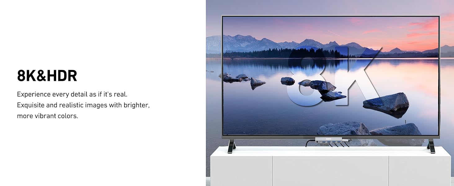 Large flatscreen 8K &amp; HDR television displaying a serene lake landscape with mountains, shown on a light gray stand.