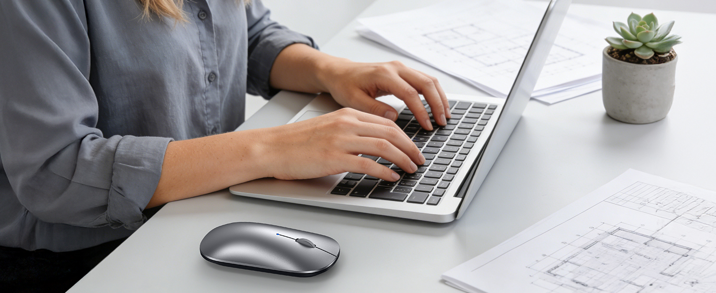 Multiple views of someone working at a desk with laptop, showing hands typing and a small potted plant visible in some frames.