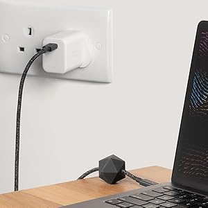 a laptop and a power cord plugged into a wall socket