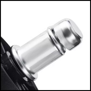 Close-up of a metallic cylindrical object with a rounded top and two visible rings, possibly part of a larger device or instrument.